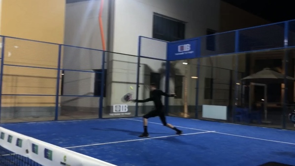 Hamza returning a a strike in a padel tennis game